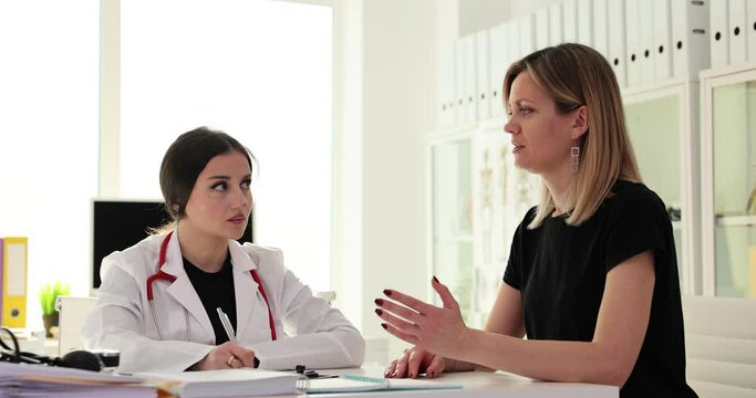 Doctor talking to female patient and asking about complaints in clinic 4k movie slow motion