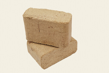 Wooden briquettes on white background. Organic pressed sawdust fuel briquettes.