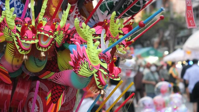 Selling toys of paper dragons at market in Bangkok 