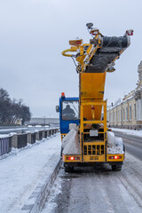Professional industrial snow plow truck cleaning road after snowstorm, snowfall. Municipal service,...