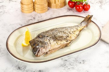 Baked Dorado fish served lemon