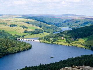 Beautiful view of Ladybower Reservoir or lake in between vibrant hills in Peak District National Park, Derbyshire, England. Seven arch bridge viaduct across the lake ads nice detail in the scenery.