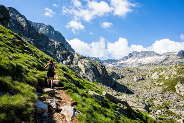 Young hiker girl summit to Ratera Peak in Aiguestortes and Sant Maurici National Park, Spain