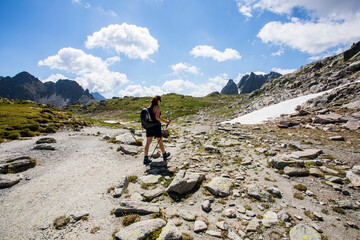 Young hiker girl summit to Ratera Peak in Aiguestortes and Sant Maurici National Park, Spain