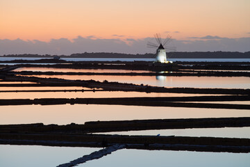 Sunset at Windmills in the salt evoporation pond in Marsala, Sicily island, Italy
Trapani salt flats and old windmill in Sicily.
View in beautifull sunny day.