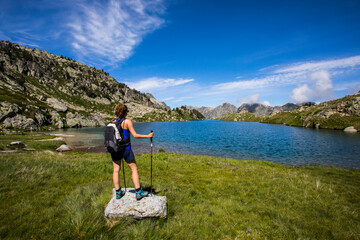 Naklejka na ściany i meble Young hiker girl summit to Montardo Peak in AIguestortes and Sant Maurici National Park, Spain