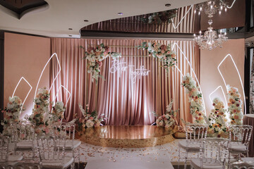 A beautifully decorated place for the wedding ceremony of the bride and groom in a modern style....