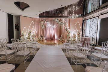 A beautifully decorated place for the wedding ceremony of the bride and groom in a modern style....