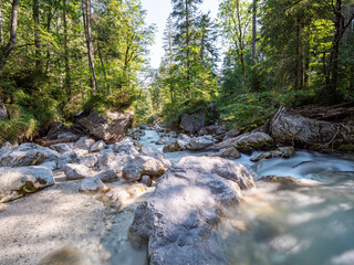 View to a wild water river at the Berchtesgaden forest during summer time 