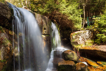 Waterfall in the forest. Beautiful waterfall in the Czech mountains.