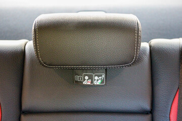 Modern vehicle center rear headrest with warning label 