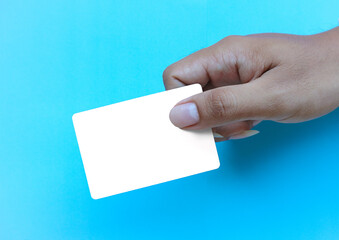 Holding White card on blue texture for graphic and space to text.