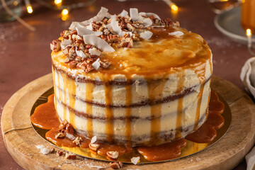 Delicious caramel cake with pecan nuts and coconut flakes