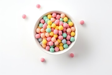 Obraz premium Colorful cereal balls on white background, viewed from above.