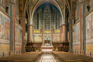 Basilica of St Francis in Assisi, Italy, interior, nave and apse of the upper basilica, frontal view with perspective on the altar and the wooden choir,  - obrazy, fototapety, plakaty