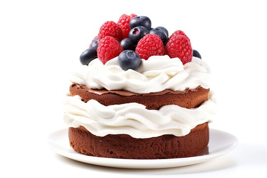 Stock image of a chocolate cake with whipped cream raspberries and blueberries on a white background