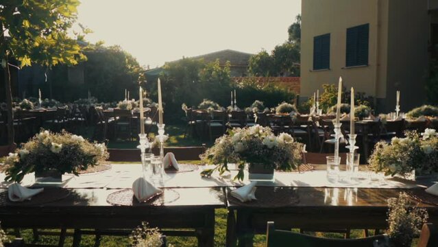 Wedding day event organization table setting decor luxury event. Wedding Decor. A large number of brown wooden chairs are lined up against the backdrop of the wedding decor. 