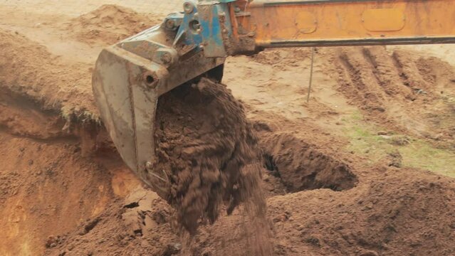 The excavator digs a hole with a telescopic rotary bucket. Pipeline replacement work, industry