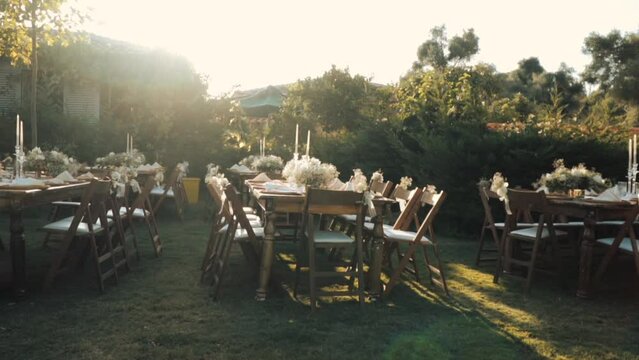 Wedding day event organization table setting decor luxury event. Wedding Decor. A large number of brown wooden chairs are lined up against the backdrop of the wedding decor. 