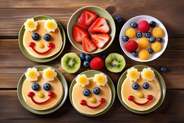 Funny face fruit pancakes for kids, served on a wooden background.