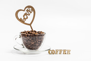 Coffee beans in a glass glass on a white background, coffee beans in a mug