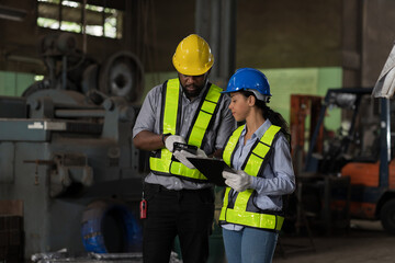 African American male and female engineer factory worker working in the industry factory area....