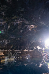 Interior of the cave of Los Jameos del Agua. Light at the end of the cave. Lanzarote, Canary Islands, Spain.