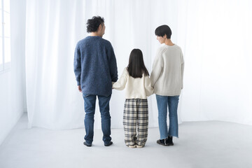 Back view of family holding hands Full body without face