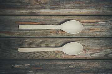 Wooden spoons on vintage background