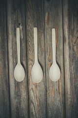 Wooden spoons on vintage background