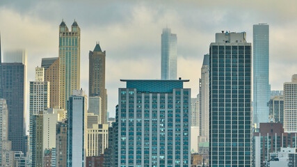 Fototapeta premium Foggy downtown skyscraper buildings in Chicago aerial, gloomy big city, daytime