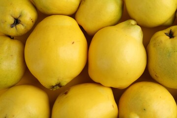 Delicious ripe quinces as background, top view