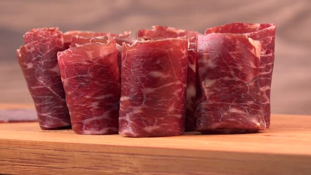 Dry-cured Spanish ham, Serrano ham, Bellota ham, Italian prosciutto crudo or Parma ham, wagyu slice. High quality video