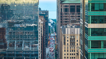 Chicago street cutting through skyscraper buildings with architecture in city aerial, tourism