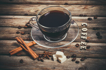 Obraz na płótnie Canvas Black coffee in a glass mug on a vintage background, aromatic coffee for energy