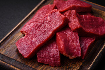 Juicy fresh raw beef meat with salt, spices and herbs