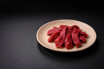 Juicy fresh raw beef meat with salt, spices and herbs
