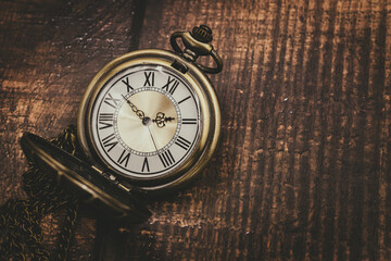 old pocket watch classic clock time vintage retro style on wood background with space for text