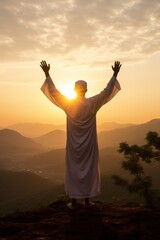 Man in white robe raising hands in sunrise prayer