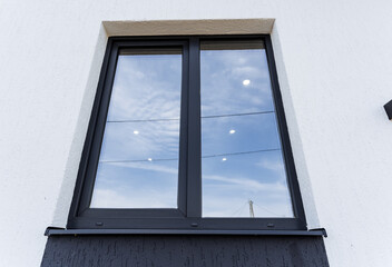 Plastic window in the house, gray double-glazed window view from the street, exterior wall of the...