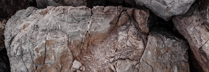 Sea cracked granite textured rock concept photo. Mediterranean sea rough surfaces.