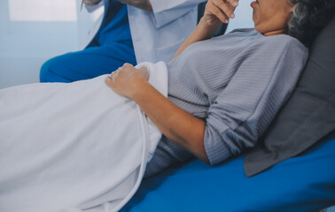 Female doctor administers specialized medical treatment to a patient in a hospital room. The procedure includes fluid therapy and injections to support the patient's health diagnosis and recovery.