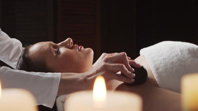 Young, healthy and beautiful woman gets massage therapy in the spa salon. The concept of healthy lifestyle and body care.