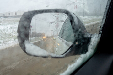 heavy snow during rush hour during snowy foggy winter day in Europe, carefully driving in bad...