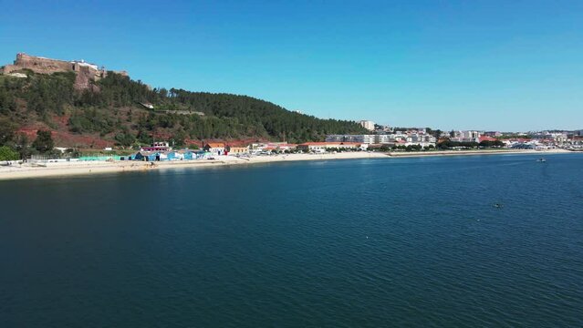 Aerial footage of the coastline underneath Forte de S&atilde;o Filipe in Set&uacute;bal, Portugal