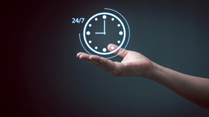 Nonstop service 24 hr concept. Man hand holding virtual 24-7 with clock on hand for worldwide...