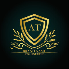 AT luxury letter logo template in gold color. Elegant gold shield icon. Modern vector Royal premium logo template vector