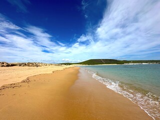 beach near Faro de Trafalgar with a view over Cala del Varadero towards cliffs and mountains behind...