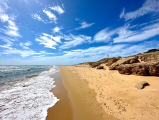 view towards the  Faro de Trafalgar, lighthouse at a sandy dune headland between Los Caños de Meca...
