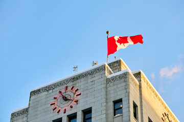 Below view Vancouver City Hall with Canadian flag.